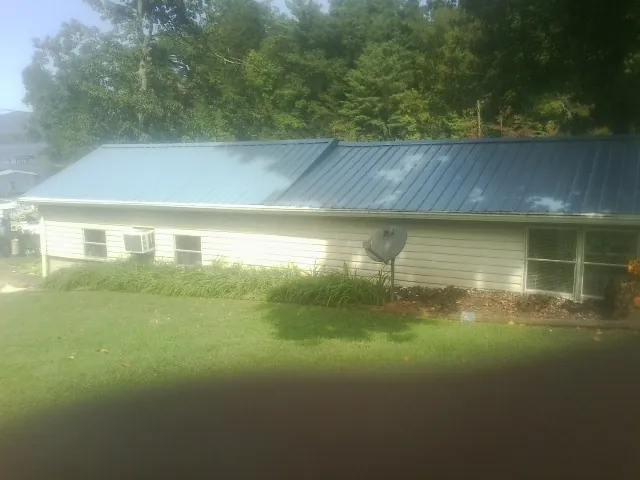 Blue metal roof running the length of a single story home in Chester Heights