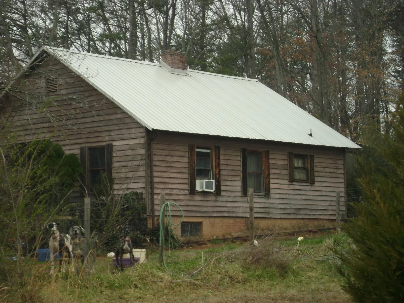 White metal roof on an old wood sided farmhouse, from a Metal Roof Installation job in Chester Heights
